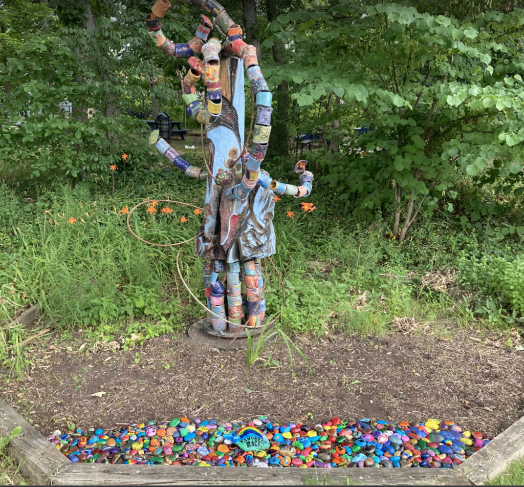 art sculpture surrounded by kindness rocks
